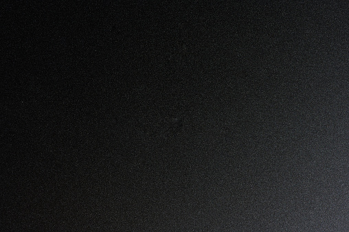 Flat surface of dark black metal macro close up view