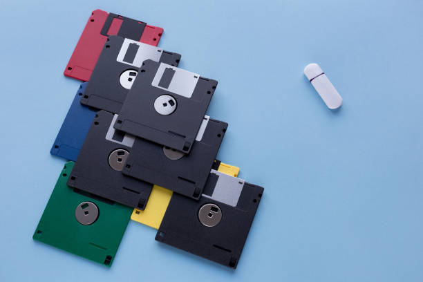istock The evolution of digital data storage device. Floppy disks vs small flash drive. Isolated on a blue background. 1166759270