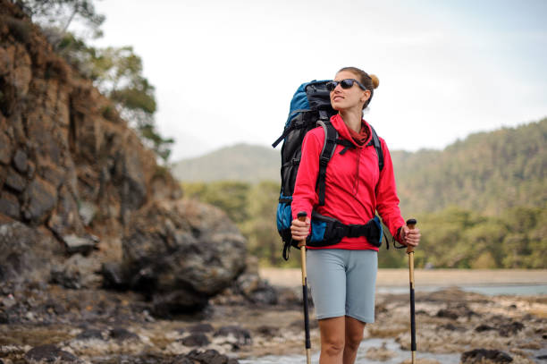 istock Female traveller stands in front of cliffs 1166759525