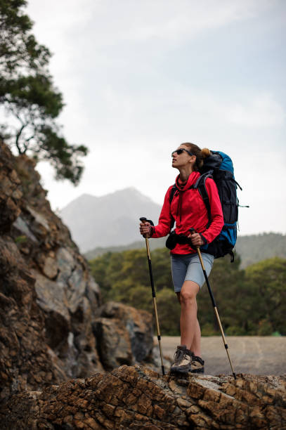 istock Female wanderer posing on top of a rock 1166759691