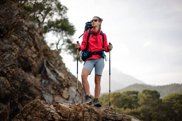 istock Traveller girl in sunglasses with backpack in mountains 1166759823