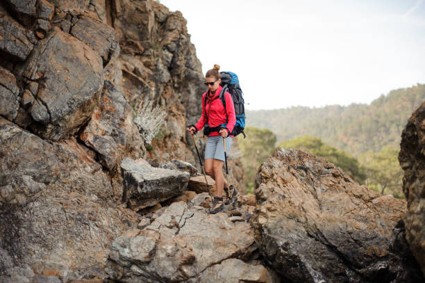 istock Travelling girl in sunglasses with backpack in mountains 1166759841