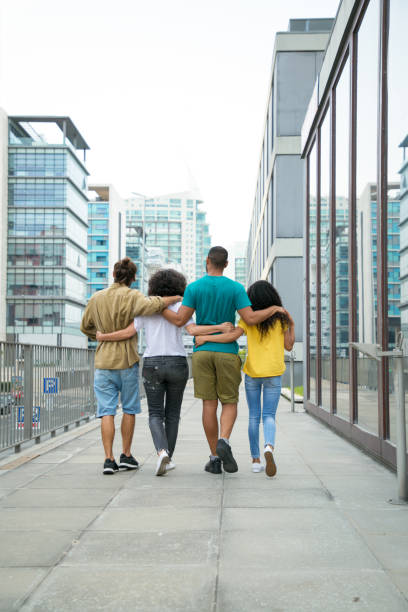 istock Close friends walking around city together 1166760914