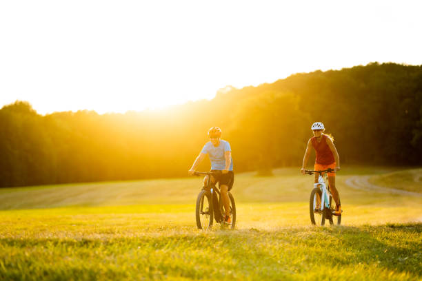 istock happy couple on mountain bikes at summer sunset 1166762072