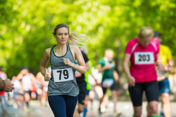 istock focused woman during running event 1166762074