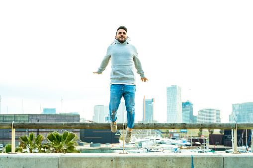 Man jumping with Barcelona skyline at background
