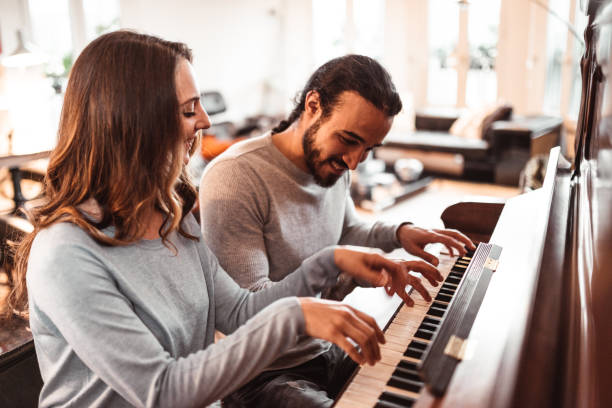istock couple playing the piano together at home 1166763400