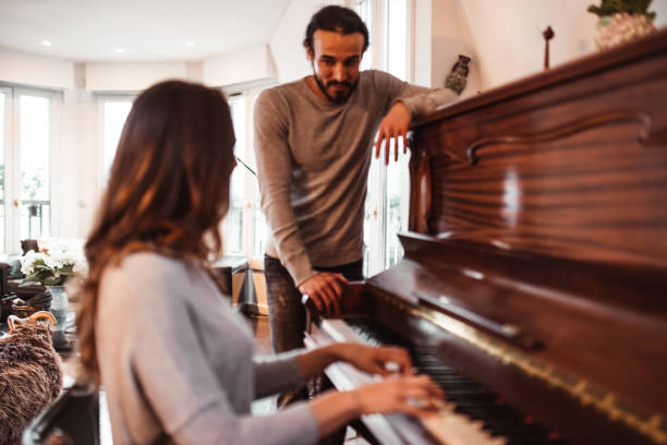 istock couple playing the piano together at home 1166763474