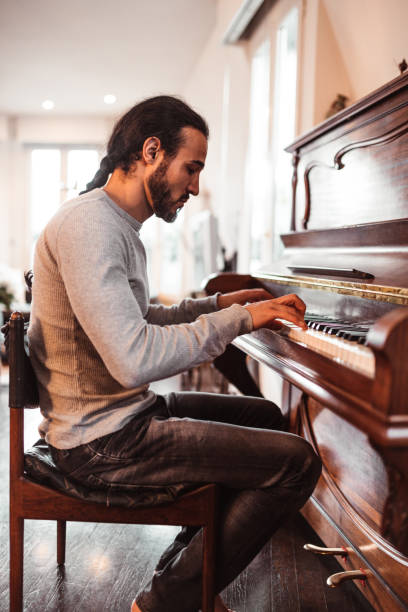 istock couple playing the piano together at home 1166763700