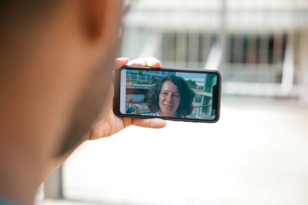 istock Speaking woman on mobile phone screen 1166765261