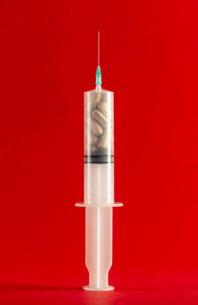 istock Syringe filled with pills 1166766506