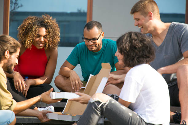 istock Happy multiethnic friends sharing pizza outside 1166768129
