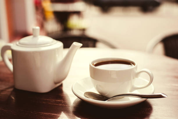 istock Teapot and cup of tea on wooden table. 1166769360