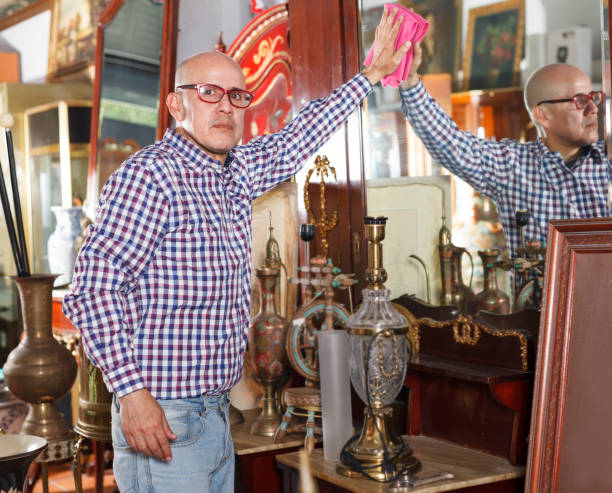 istock vendor  wiping dust on ancient items 1166769603