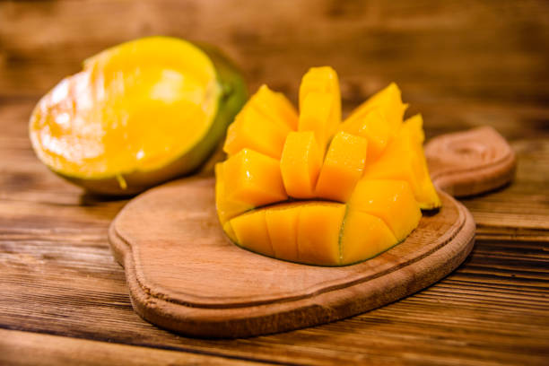 istock Cutting board with chopped mango fruit on a wooden table 1166769738
