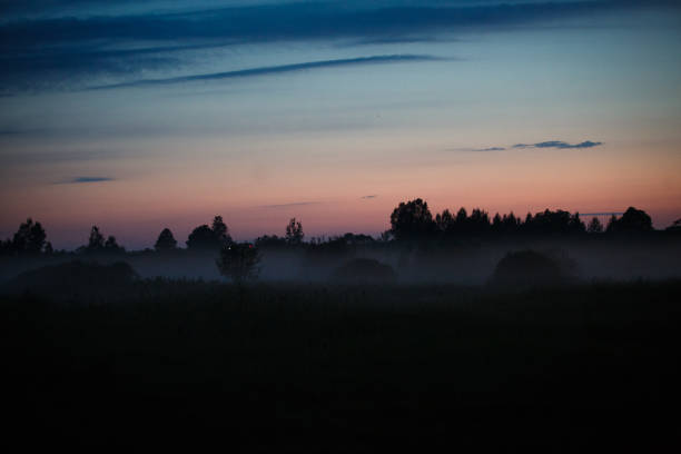 istock Evening fog creeps over the river and forest. 1166771337