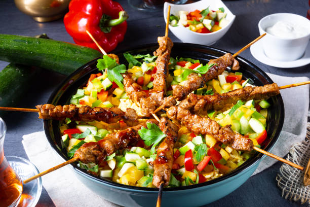 istock Lamb skewers with curry rice and different vegetables 1166771377