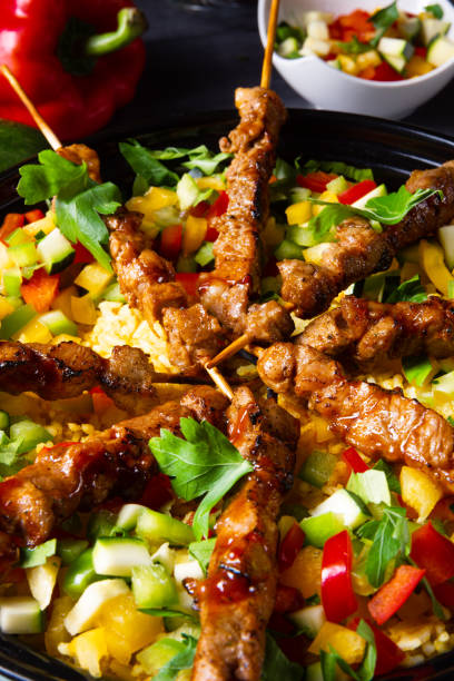 istock Lamb skewers with curry rice and different vegetables 1166771399