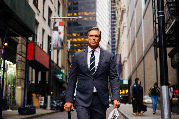 Smiling businessman standing outdoorshttp://www.twodozendesign.info/i/1.png
