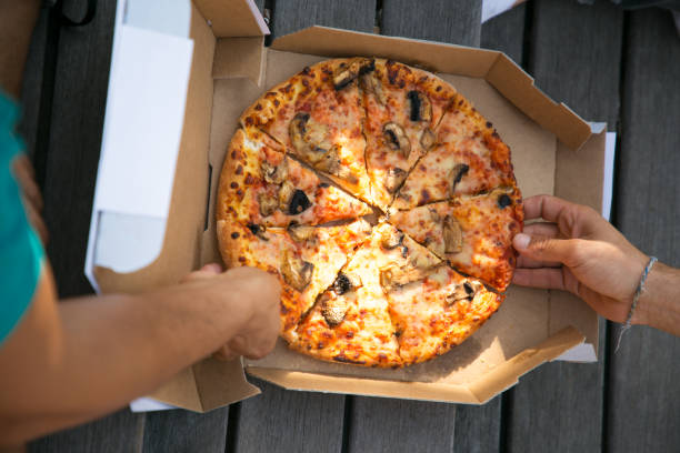 istock Top view of pizza in paper box 1166771753