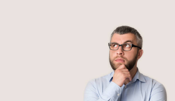 istock Thinking middle-aged bearded businessman is looking away 1166771869