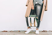 Close up image woman autumn city casual outfit with shopper bag