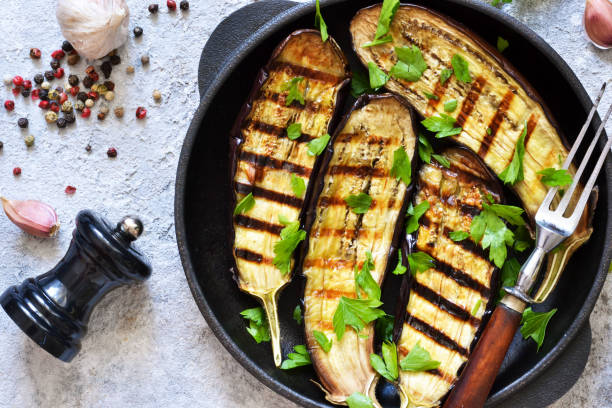 istock Spicy eggplant grilled in a cast-iron frying pan on a concrete background. 1166773321