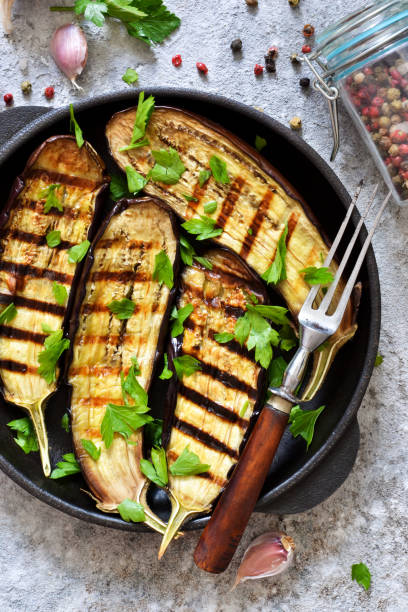 istock Spicy eggplant grilled in a cast-iron frying pan on a concrete background. 1166773334