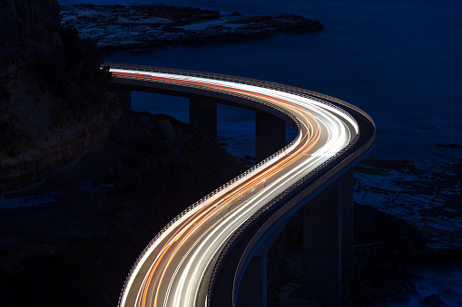 Car light trails on Sea Cliff Bridge, a balanced cantilever bridge located south of Sydney, New South Wales, Australia