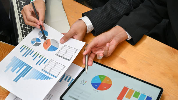 istock Consulting business with two man analysis finance data with device and paper document. 1166774104