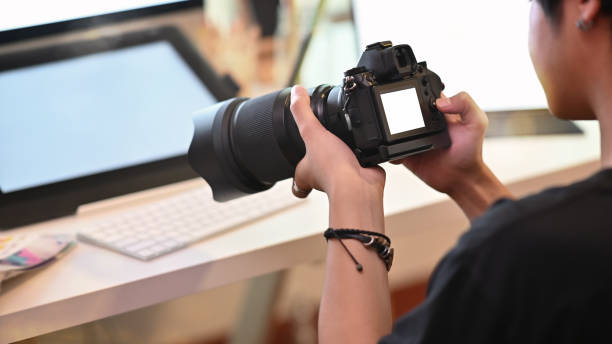 istock A Man photographer using professional camera and blank screen display. 1166774115