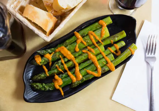Photo of Top view of grilled asparagus with romesco