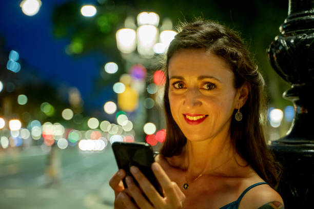 istock Beautiful woman sending a text message 1166775562