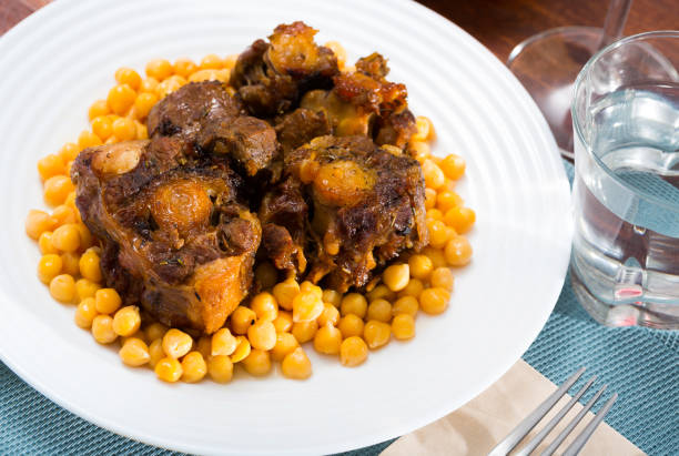 istock Braised oxtails with chickpeas on a white plate 1166775602