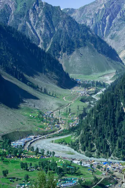 Famous Zoji La mountain pass on the road between Ladakh (Leh) and Kashmir (Srinagar). The image shoes the end of the pass on the western side, close to the village of Sonamarg. The road is called Indian National Highway, crosses several high mountain passes, the most well known are Fatu La (4.100 m) and Zoji La (3.528 m altitude). In the valley the camp of the pilgrims of Amarnath Yatra (pilgrimage) are visible.