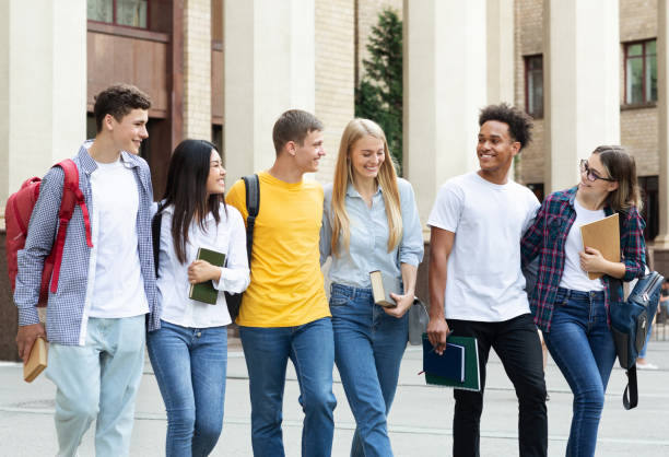 istock Education concept. Classmates walking in college campus 1166776178