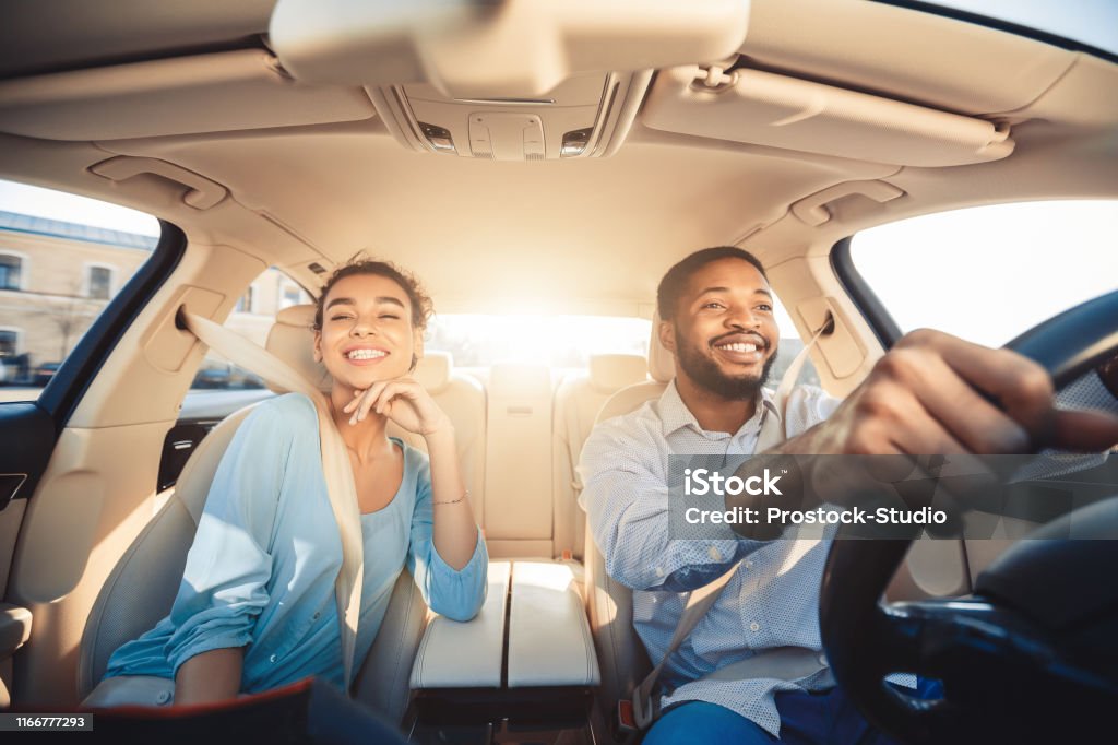 Enjoying travel. Excited african couple driving car Enjoying travel. Excited african couple driving car and smiling, copy space Car Stock Photo