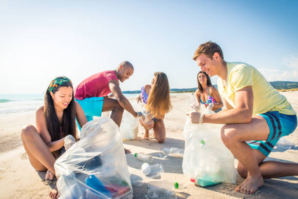 istock Volunteers collecting plastic on the beach 1166777583