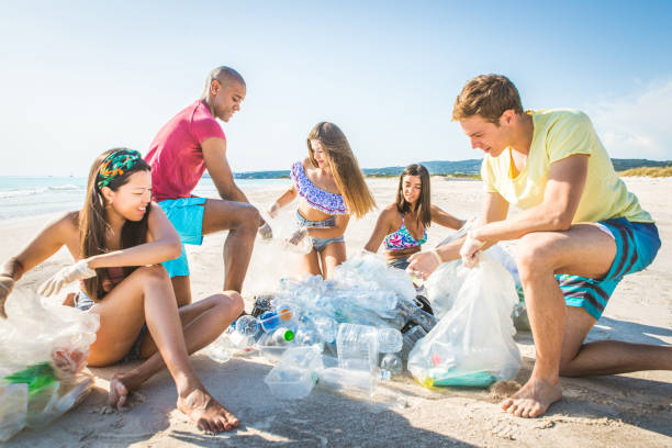 istock Volunteers collecting plastic on the beach 1166777605
