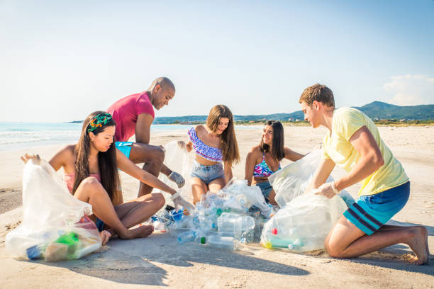 istock Volunteers collecting plastic on the beach 1166777635