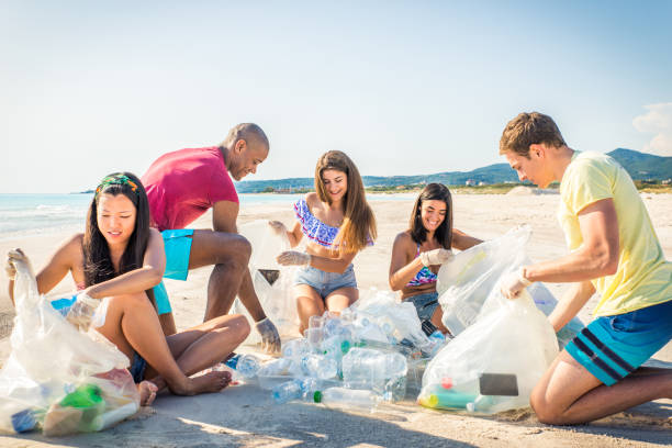 istock Volunteers collecting plastic on the beach 1166777644