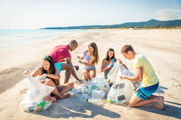 istock Volunteers collecting plastic on the beach 1166777659