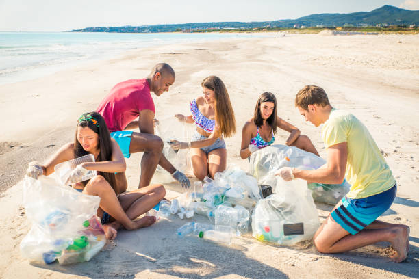 istock Volunteers collecting plastic on the beach 1166777686