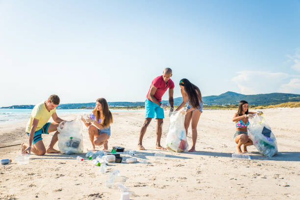 istock Volunteers collecting plastic on the beach 1166777741