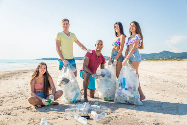 istock Volunteers collecting plastic on the beach 1166777789
