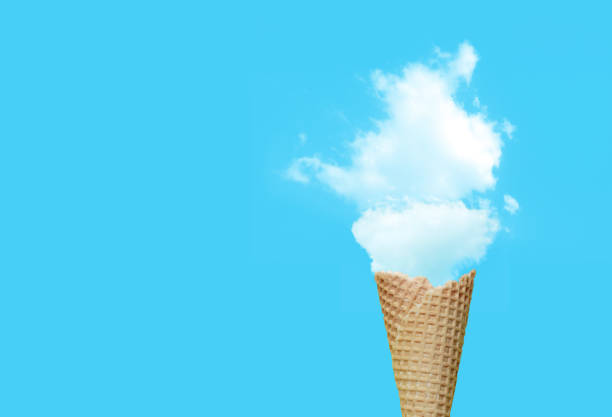 istock Summer Vacation and Holiday Concept : Ice cream cone with white cloud in blue background. 1166777910