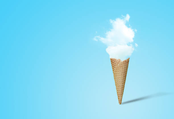 istock Summer Vacation and Holiday Concept : Ice cream cone with white cloud in blue background. 1166777911