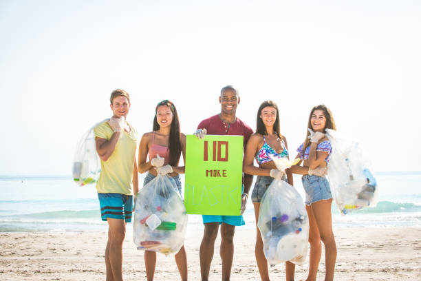 istock Volunteers collecting plastic on the beach 1166778008