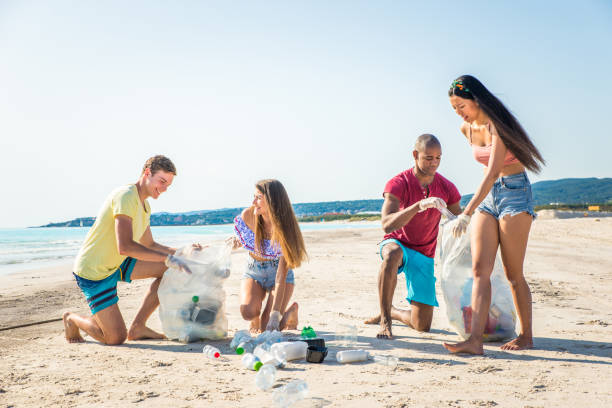 istock Volunteers collecting plastic on the beach 1166778067
