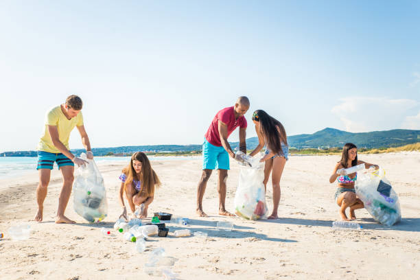 istock Volunteers collecting plastic on the beach 1166778076